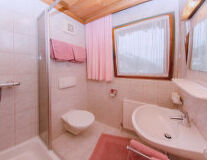 a close up of pink tub and sink